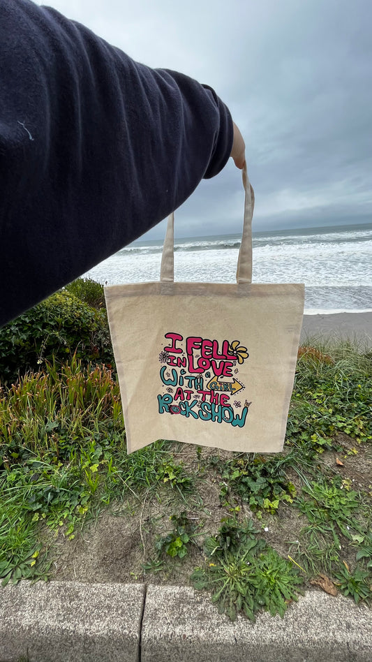 Canvas tote bag that says I fell in love with a girl at the rock show designed by me digitally in my hand doodled letters - it’s a song lyric from blink 182 